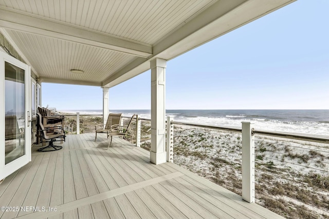 wooden terrace with a water view and a beach view