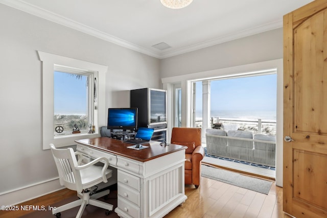 office area with crown molding, light wood-style flooring, and baseboards