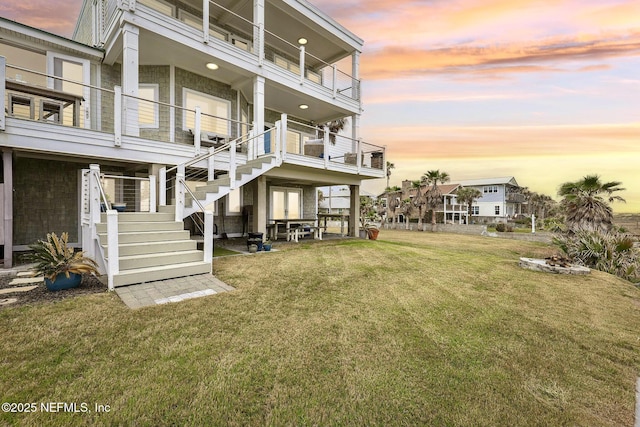 exterior space featuring stairs and a yard