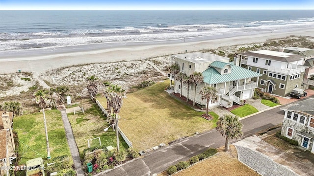 birds eye view of property with a view of the beach and a water view