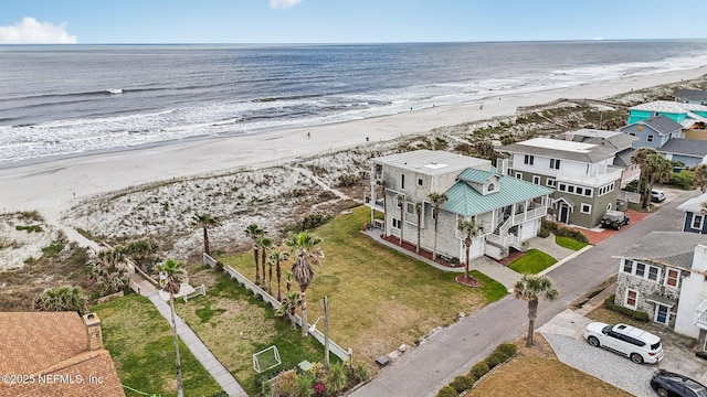 drone / aerial view with a water view and a view of the beach