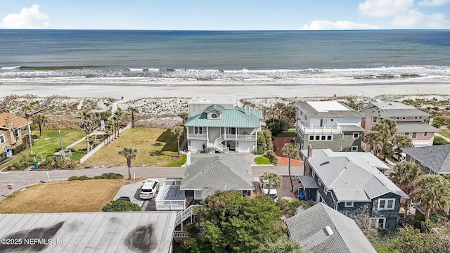 birds eye view of property with a view of the beach, a water view, and a residential view