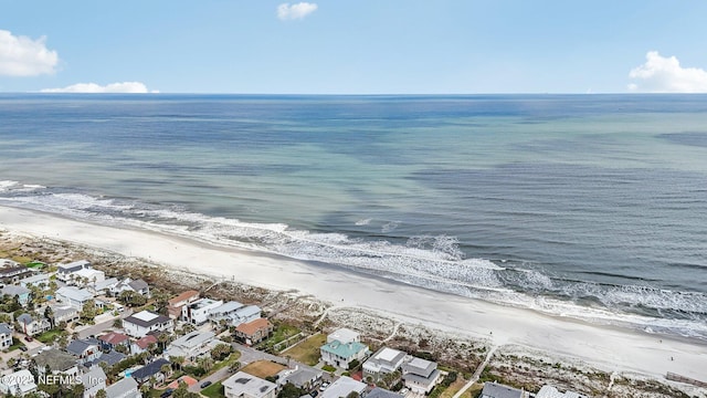 birds eye view of property featuring a water view, a residential view, and a view of the beach