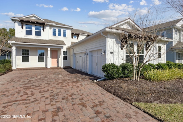 view of front of house with decorative driveway and an attached garage