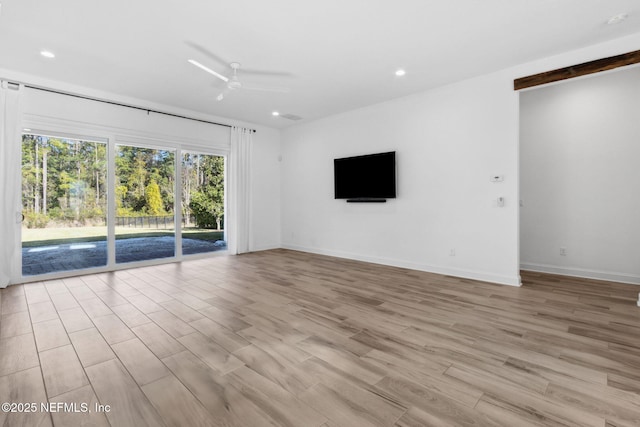 unfurnished living room featuring light wood-style floors, ceiling fan, and baseboards