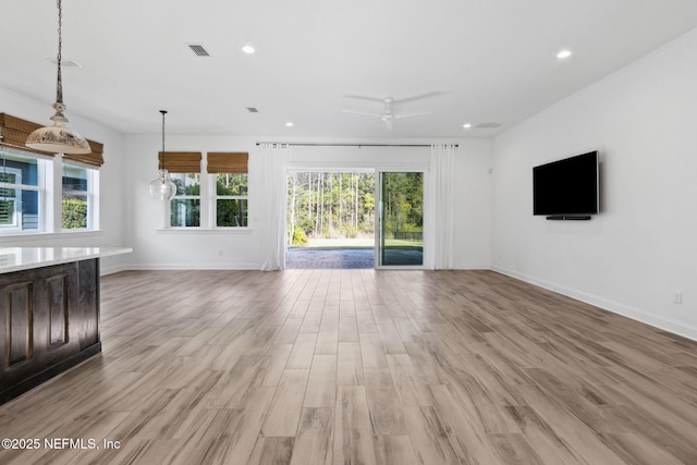 unfurnished living room featuring recessed lighting, baseboards, visible vents, and light wood finished floors