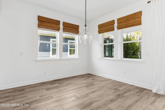 empty room featuring baseboards and wood finished floors