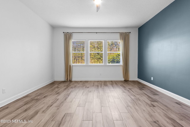 unfurnished room featuring wood finished floors and baseboards