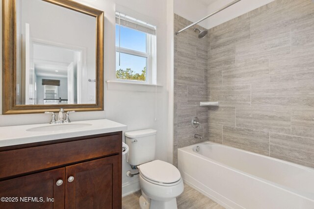 full bathroom featuring bathtub / shower combination, vanity, and toilet