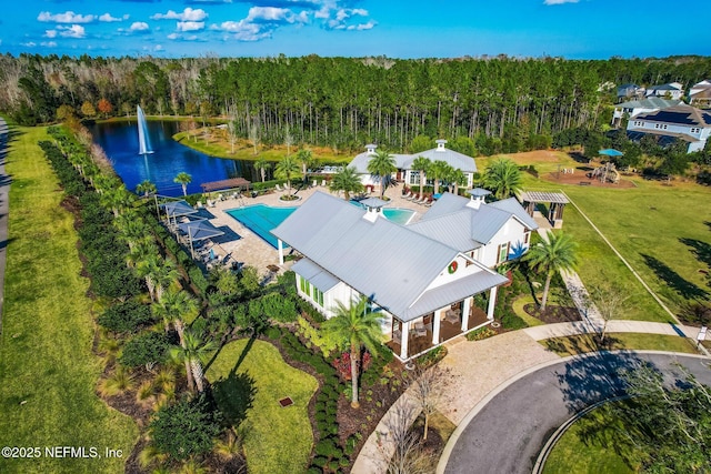 bird's eye view featuring a forest view and a water view