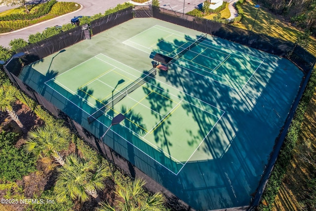 view of tennis court featuring fence