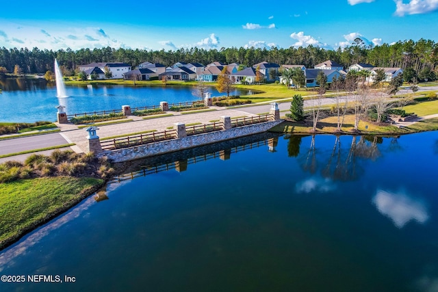 drone / aerial view with a water view and a residential view