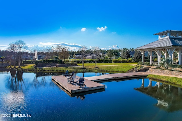 view of swimming pool featuring a gazebo, a water view, and a floating dock