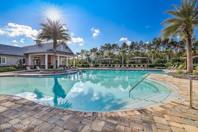 community pool with a patio area