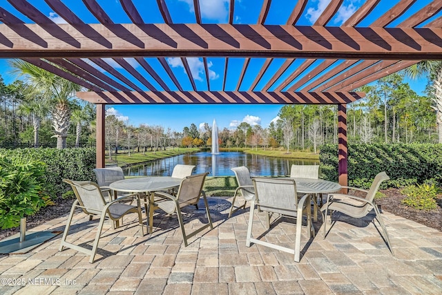 view of patio / terrace with a water view, a pergola, and outdoor dining space