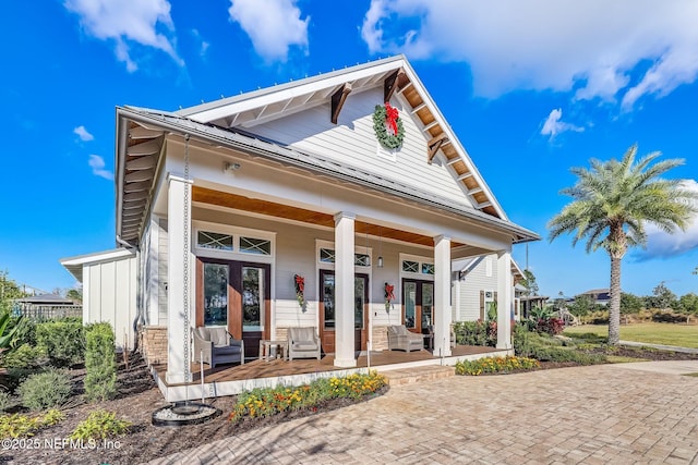 view of front of property featuring a porch and french doors