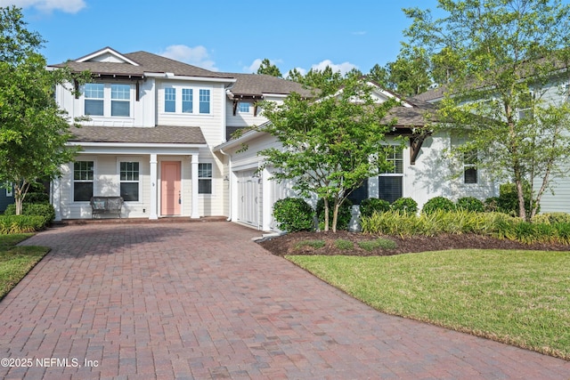 21 Mollusk Rd, Saint Johns, FL 32259 - view of front facade featuring an attached garage, a front lawn, and decorative driveway