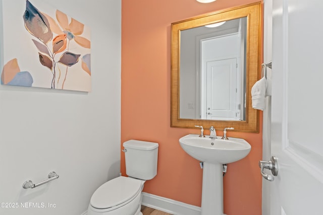 21 Mollusk Rd, Saint Johns, FL 32259 - half bathroom featuring a sink, baseboards, and toilet
