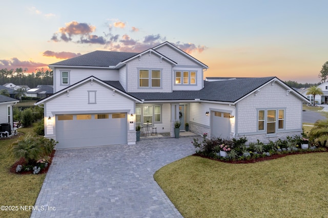 view of front facade with a garage and a yard