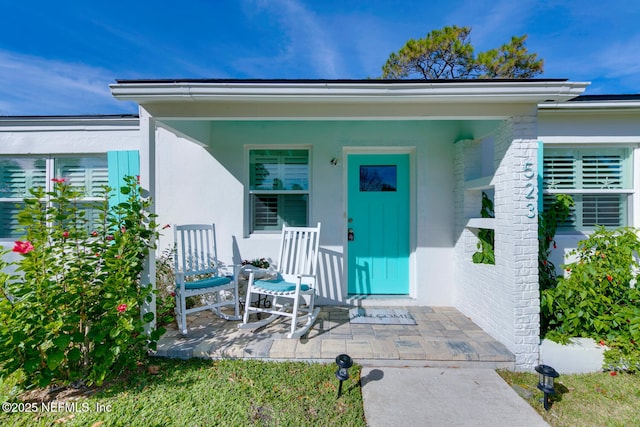 doorway to property with a porch