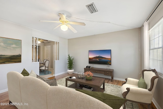 living room featuring ceiling fan and hardwood / wood-style floors