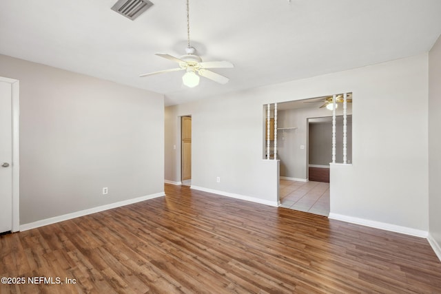 spare room featuring hardwood / wood-style floors and ceiling fan