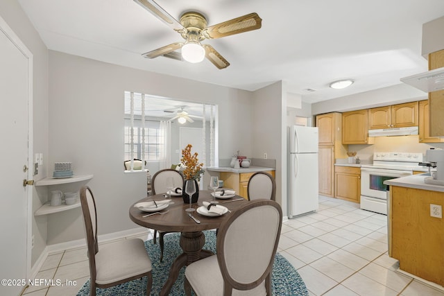 tiled dining space with ceiling fan