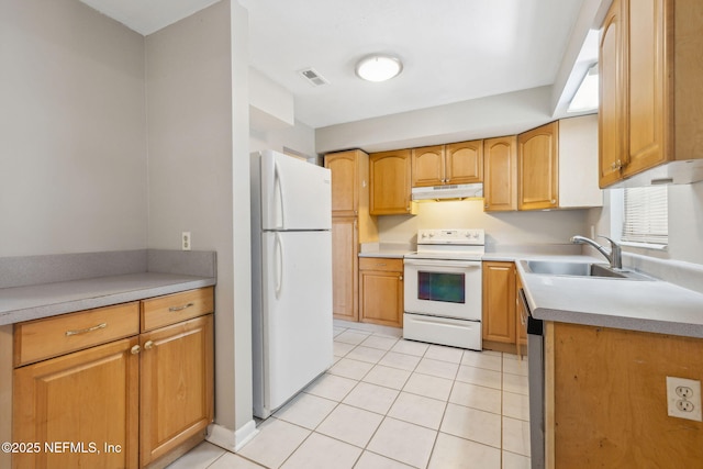 kitchen featuring sink, white appliances, and light tile patterned floors