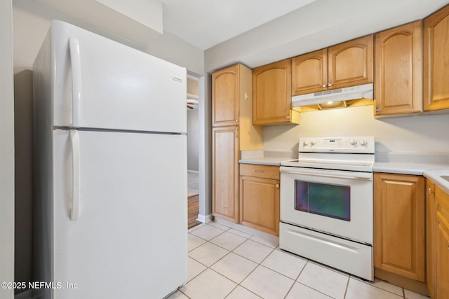 kitchen with light tile patterned floors and white appliances