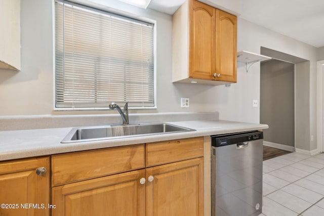 kitchen featuring sink, light tile patterned floors, and stainless steel dishwasher