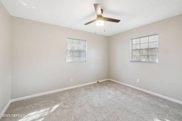 empty room featuring ceiling fan and light colored carpet