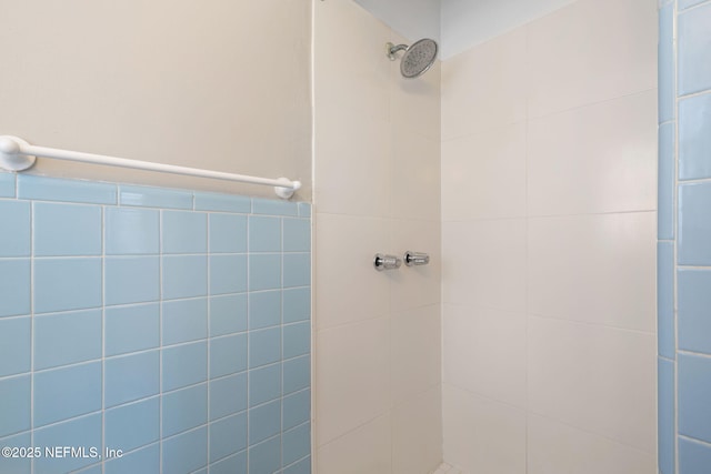 bathroom with a tile shower