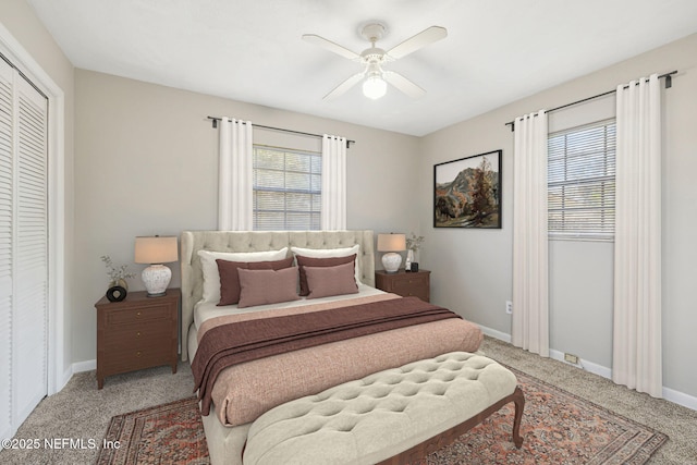 carpeted bedroom featuring ceiling fan, a closet, and multiple windows