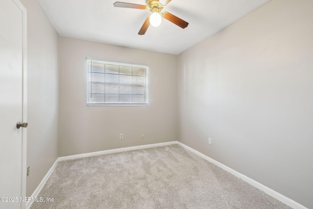 spare room featuring light colored carpet and ceiling fan