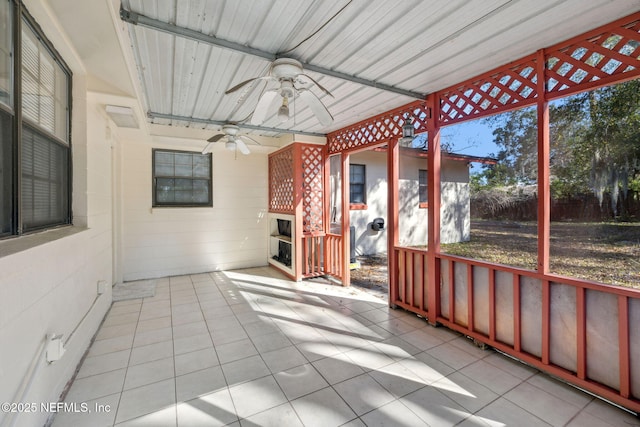 unfurnished sunroom with a wealth of natural light and ceiling fan