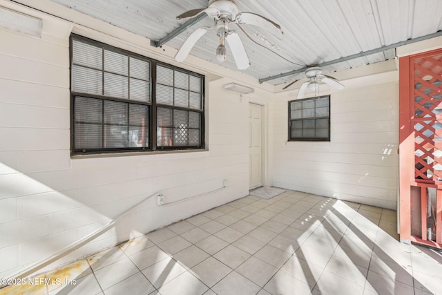 tiled spare room featuring wood ceiling and ceiling fan