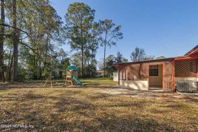 view of yard featuring a playground and central air condition unit