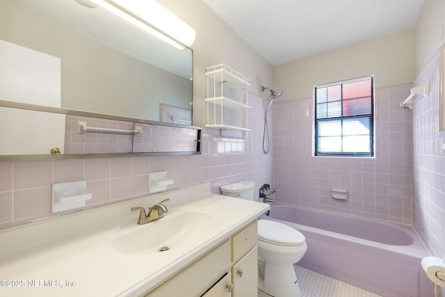 full bathroom with tile walls, tile patterned flooring, tiled shower / bath combo, vanity, and toilet