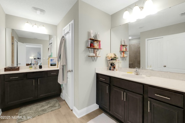 bathroom featuring vanity, a notable chandelier, and wood-type flooring