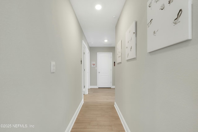 corridor with light wood-type flooring