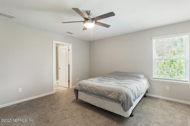 bedroom with light carpet, multiple windows, and ceiling fan