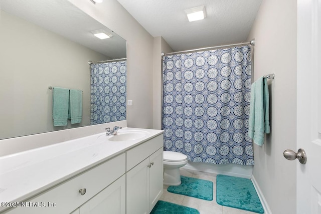 bathroom featuring vanity, toilet, tile patterned flooring, and a textured ceiling