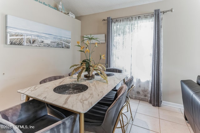 1045 17th St N, Jacksonville Beach, FL 32250 - dining room featuring a textured ceiling, light tile patterned flooring, and baseboards