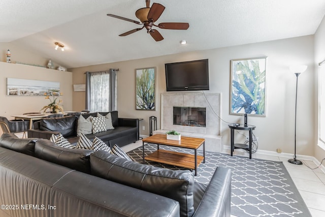 1045 17th St N, Jacksonville Beach, FL 32250 - living area with baseboards, a ceiling fan, lofted ceiling, a fireplace, and light tile patterned flooring