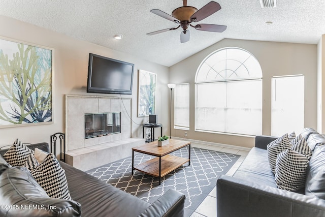 1045 17th St N, Jacksonville Beach, FL 32250 - living room featuring plenty of natural light, light tile patterned floors, vaulted ceiling, and a fireplace