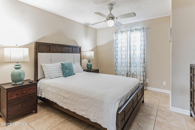 1045 17th St N, Jacksonville Beach, FL 32250 - bedroom featuring light tile patterned floors, a ceiling fan, baseboards, and a textured ceiling