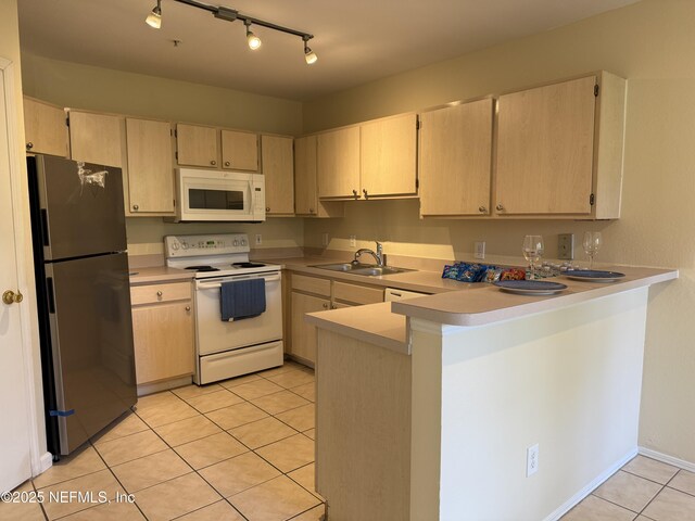 1701 The Greens Way Unit 1821, Jacksonville Beach, FL 32250 - kitchen with white appliances, a sink, a peninsula, light tile patterned floors, and light countertops
