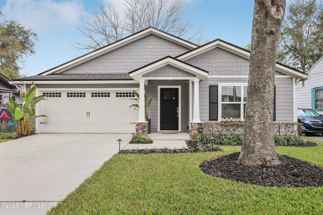 craftsman-style house with a garage, concrete driveway, and a front yard