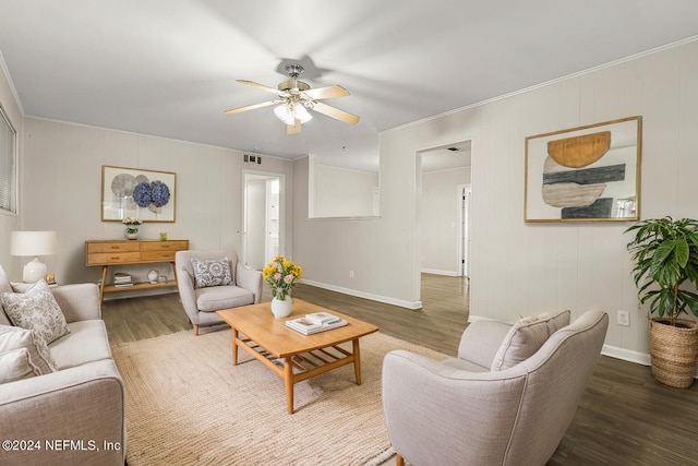 living room with ceiling fan, crown molding, and dark hardwood / wood-style flooring