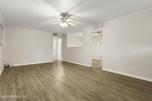 spare room with crown molding, ceiling fan, and dark hardwood / wood-style floors